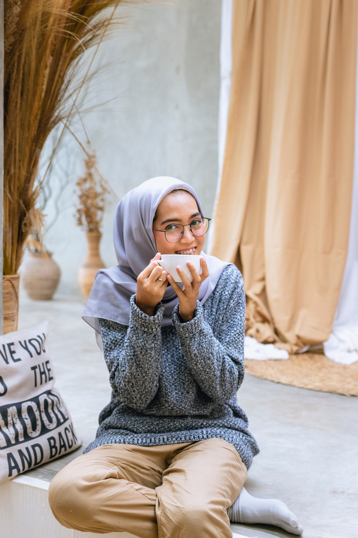 Happy Woman Holding Cup of Coffee at Home